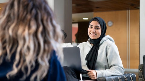 Student smiling with laptop