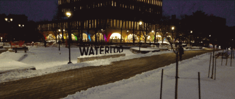 Night drone shot towards Dana Porter Library