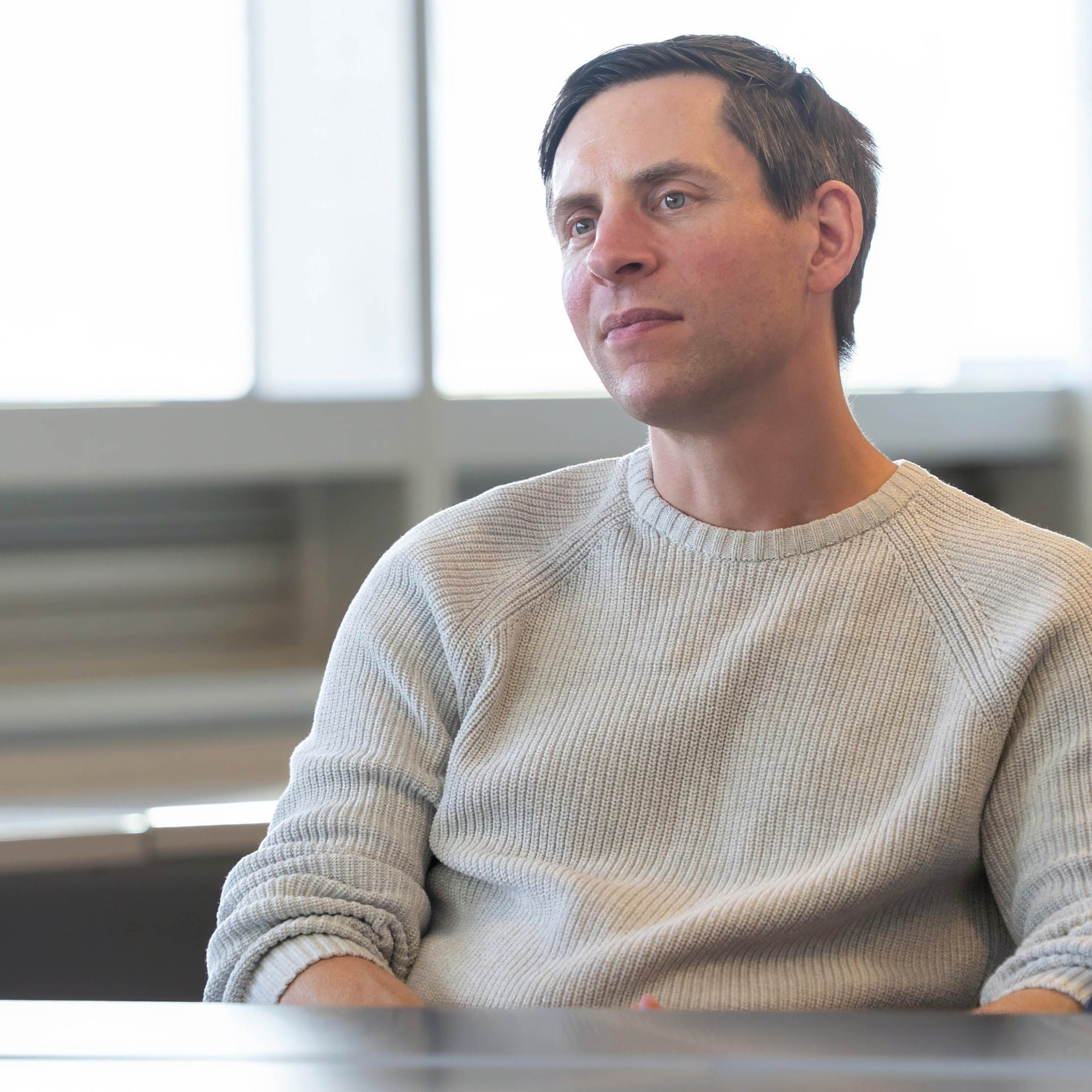 Doug Kavanagh sitting in front of a big window