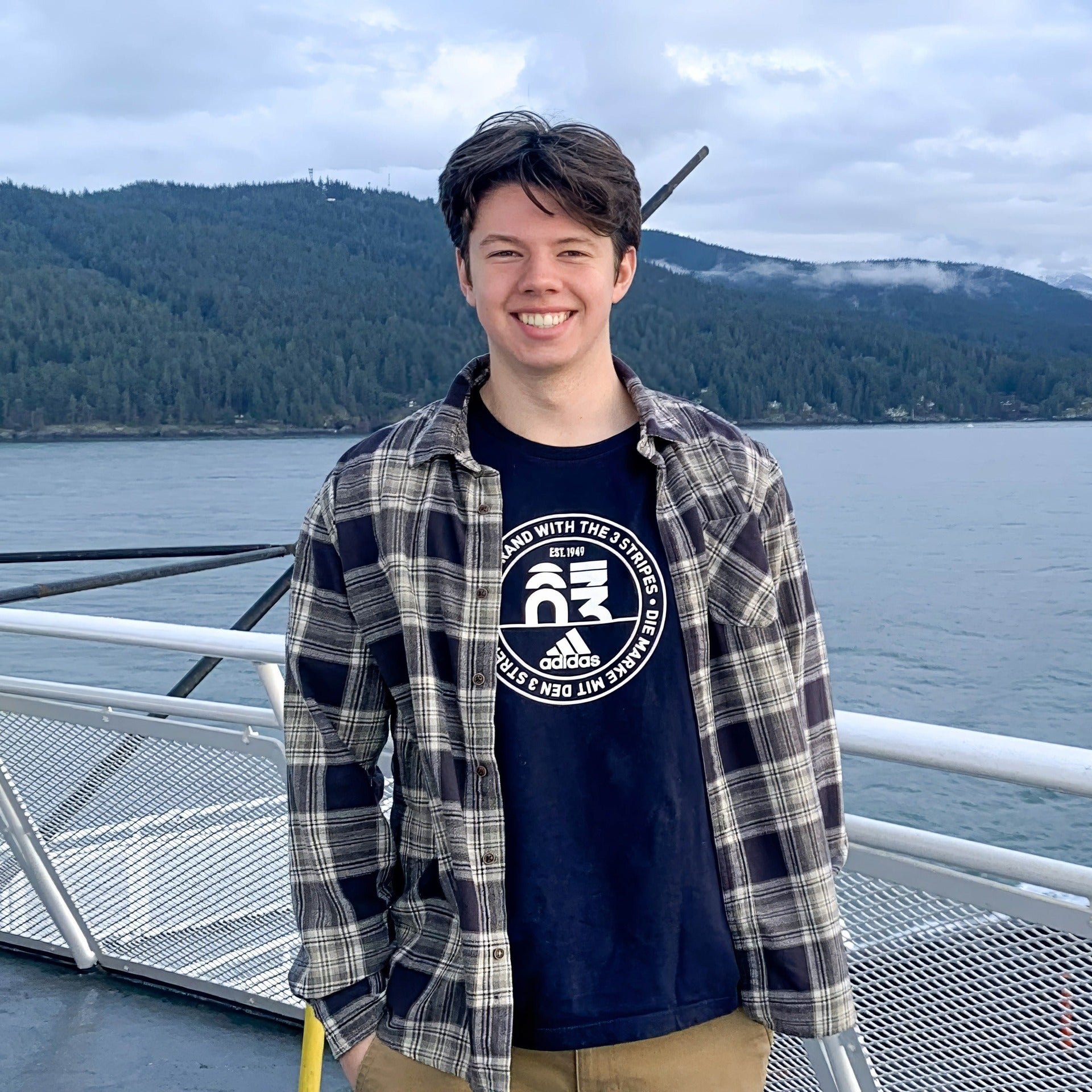 Thomas Coleman wearing a plaid longsleeve top and khakis on a ferry boat to Vancouver Island