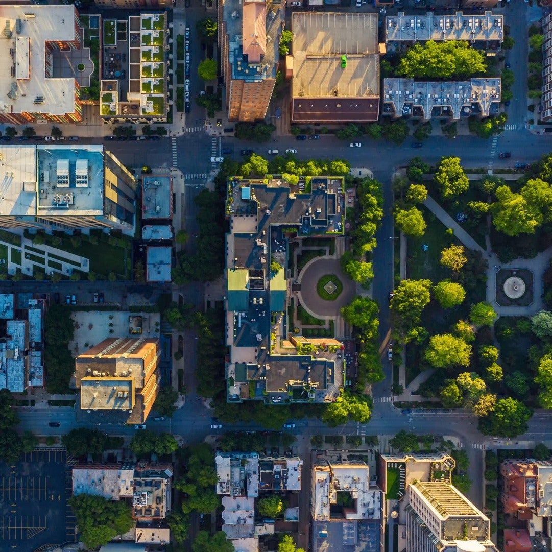 An aerial view of a city with buildings and a park
