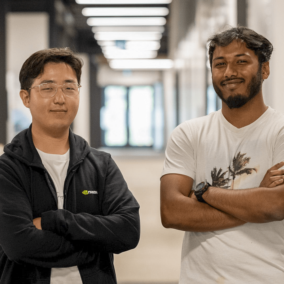 Seungmin Hong and Ahnaf Shahriar arms cross in the middle of Velocity incubator hallway