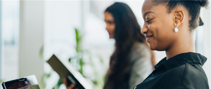 A student smiling looking down on their notes