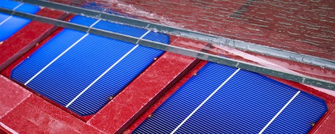 Blue solar panels with red backing and glass on top 
