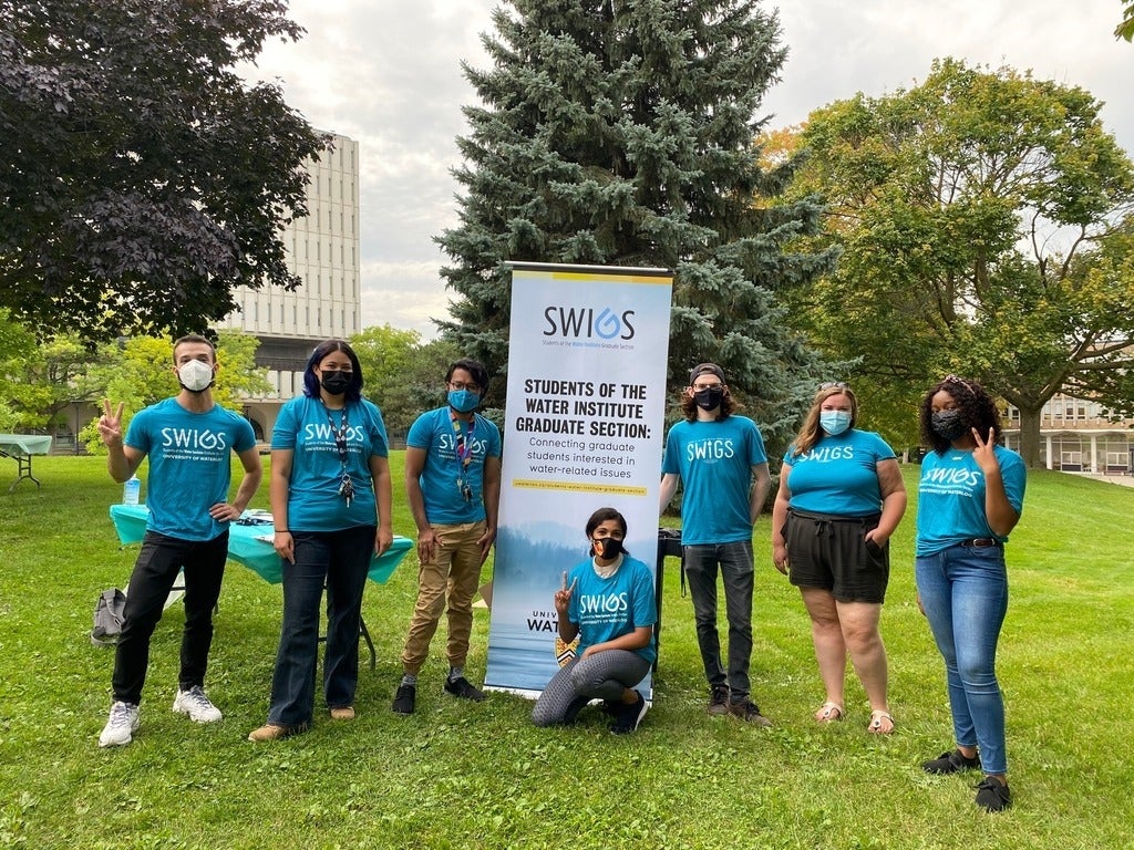 SWIGS executive around SWIGS banner