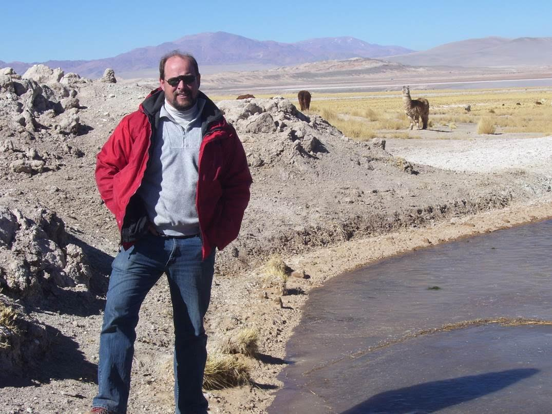 Steve Usher standing in front of a desert background