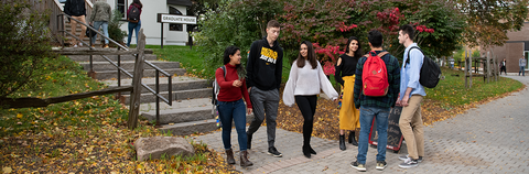 students leaving graduate house