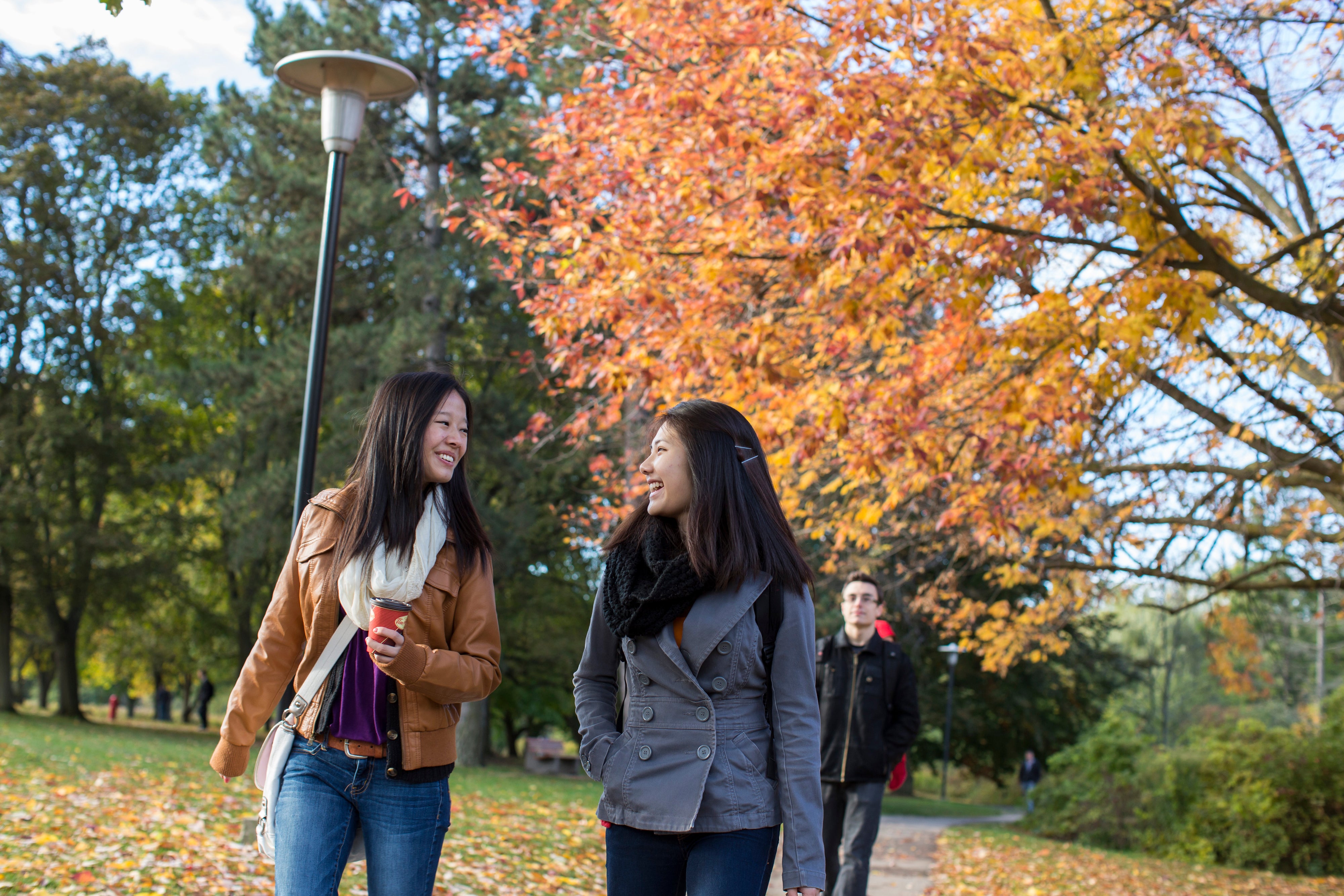 two students walking on campus in the Fall.