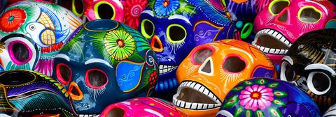 Brightly coloured and intricately decorated ceramic skulls for sale for Day of the Dead
