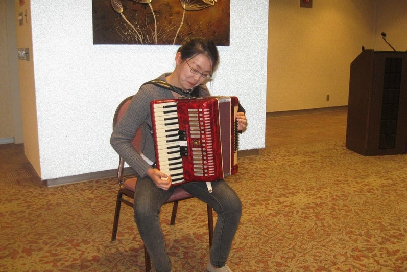 Photo of Ming Zen playing “Spanish Bullfight” on the accordion