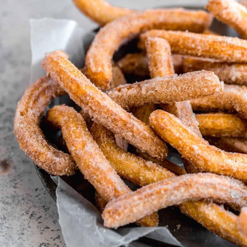A container of churros - long, finger-like fried dough covered in sugar