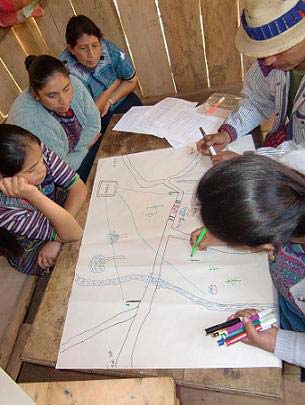 Guatemalan women working on a project map