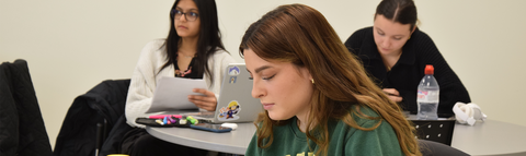 three students in a classroom