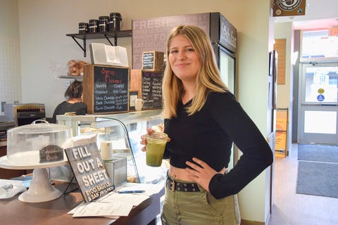 Gen Iozzo holding a coffe in the Funken Café