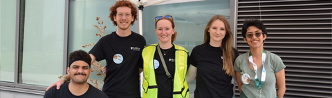 Student leaders standing side by side helping at move-in