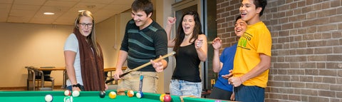 Students playing pool in the Fireside Lounge