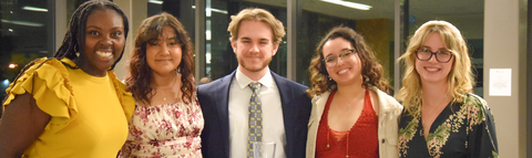 a group of student in a line facing the camera smiling