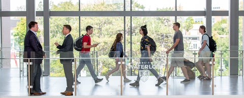 Students and faculty walking through the second floor of the St. Jerome's University Atrium.