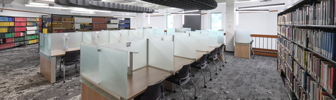 Study area in library and stacks of book shelves