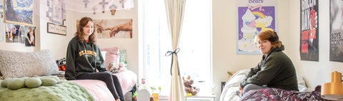 Two students sit on their beds in St. Jerome's Siegfried and Ryan Hall