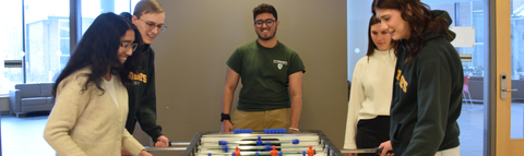 Students play at the air hockey table in St. Jerome's residence games room