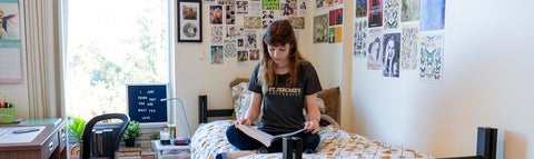 A student studying in a single room residence