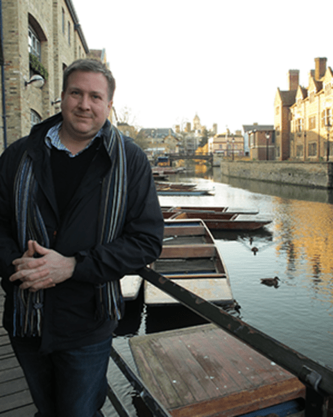 Ryan Touhey stands in front a a canal in Venice