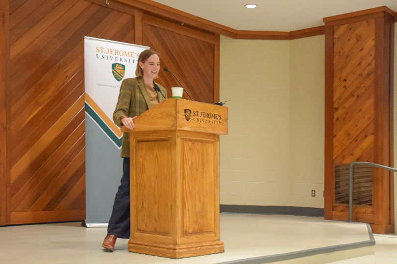Colleen Dulle standing in front of the podium at St. Jerome's University Chapel