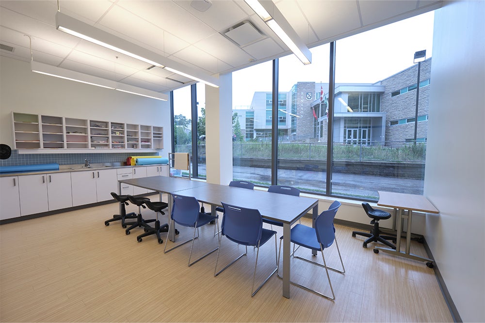 The Buttery space with chairs, table, counters and cupboards