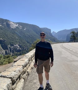Gary Whetung standing in front of mountains
