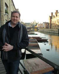 Ryan Touhey stands in front a a canal in Venice