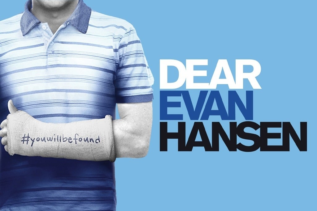 The official Dear Evan Hansen promo image features just the torso of a male-coded person wearing a striped polo shirt and a forearm cast with the hashtag #youwillbefound written on the cast.