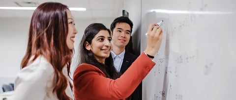 Students writing on whiteboard