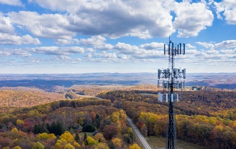 Cell phone tower in front of landscape