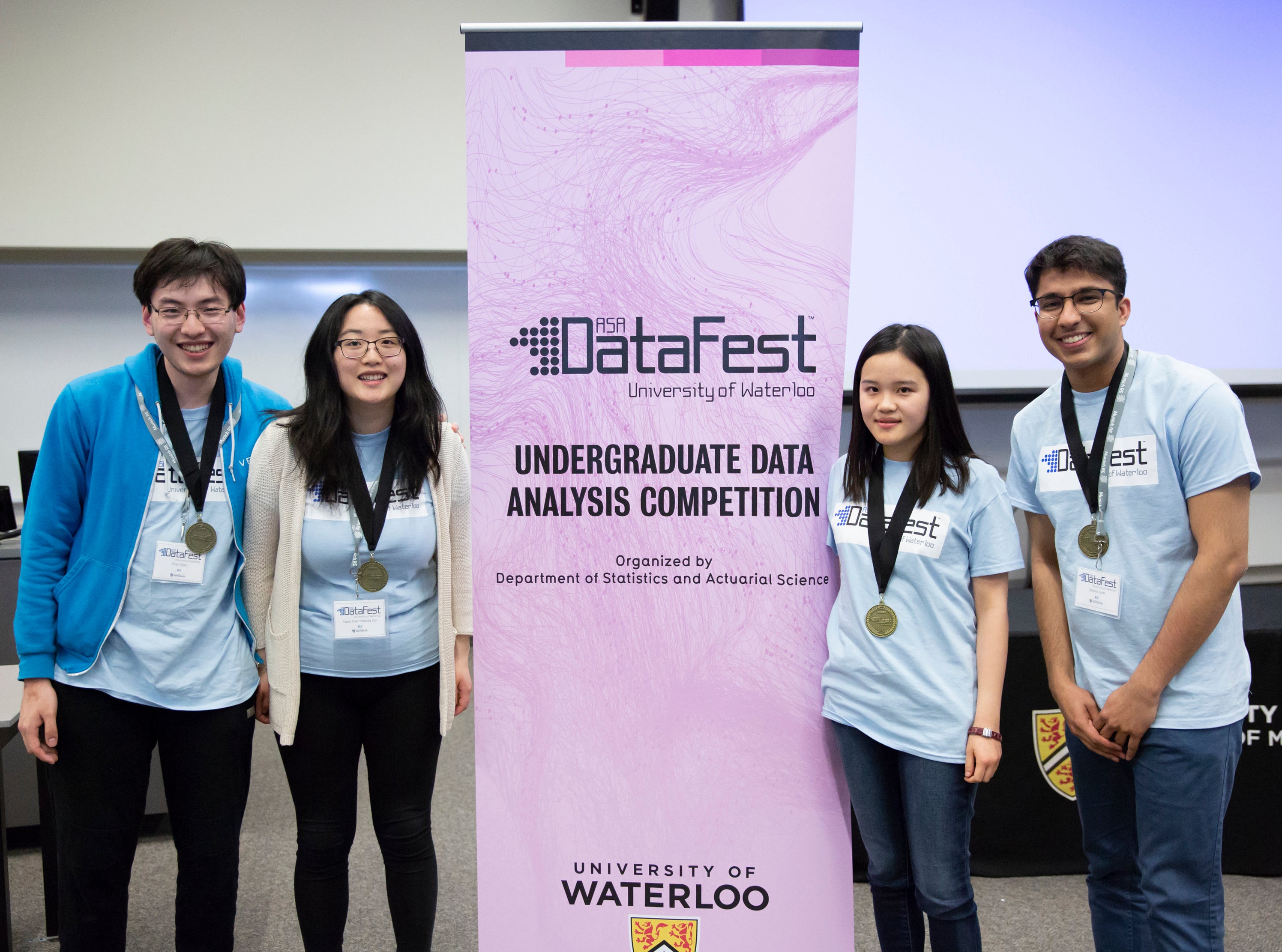 Students posing around datafest sign