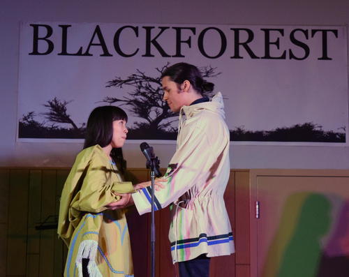 Two students performing Inuit throat singing on stage
