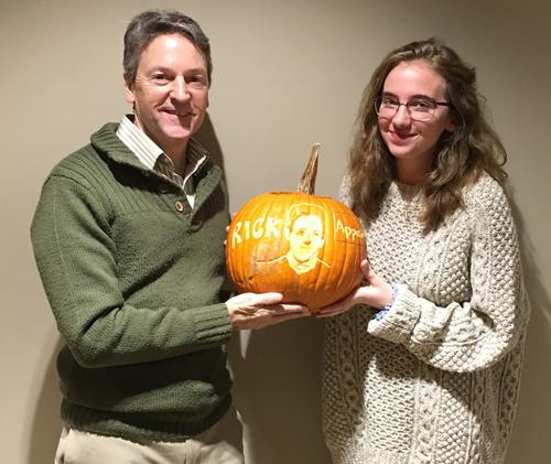 Rick Myers and a student from La Bastille hold up the winning jack o'lantern, carved to resemble Rick