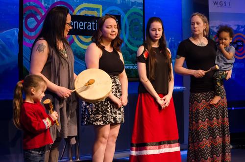 All female singing group perform with traditional hand drum