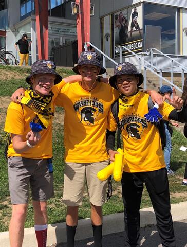 Jacob Toldi and two other students wearing Waterloo Warriors gear