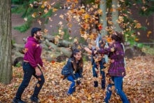 Students playing in the fallen leaves