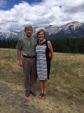 Karen Koivumaki and her husband pose with mountains in the background