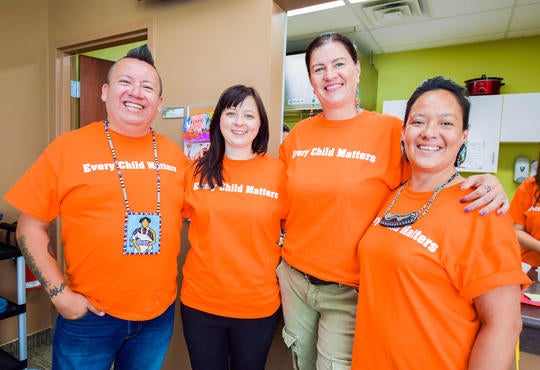 Waterloo Aboriginal Education Centre staff pose wearing orange shirts