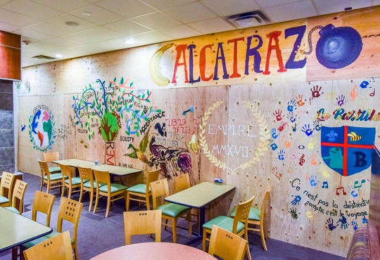 Mural created by students on construction barrier in Watson's eatery