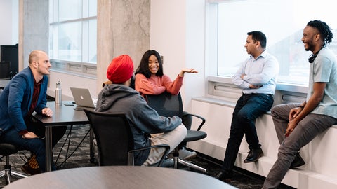 A group of people in a classroom collaborating