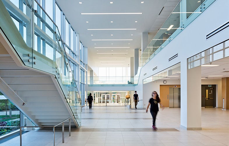 Students walk in the new Applied Health Sciences expansion building.