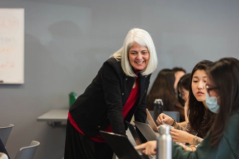 Professor smiling while teaching students