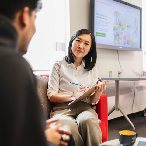 A user-testing interviewer listens closely to their test participant