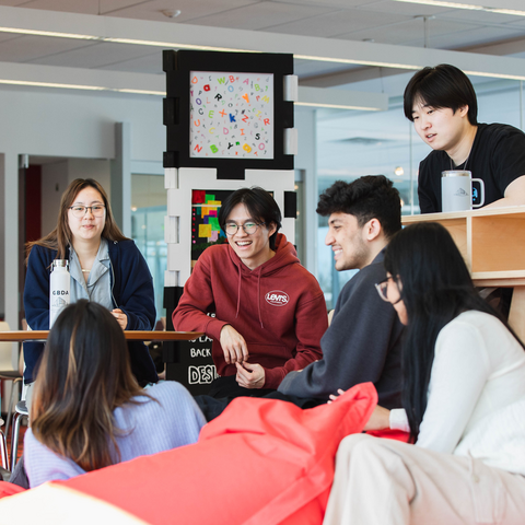 Students on campus laughing at a joke