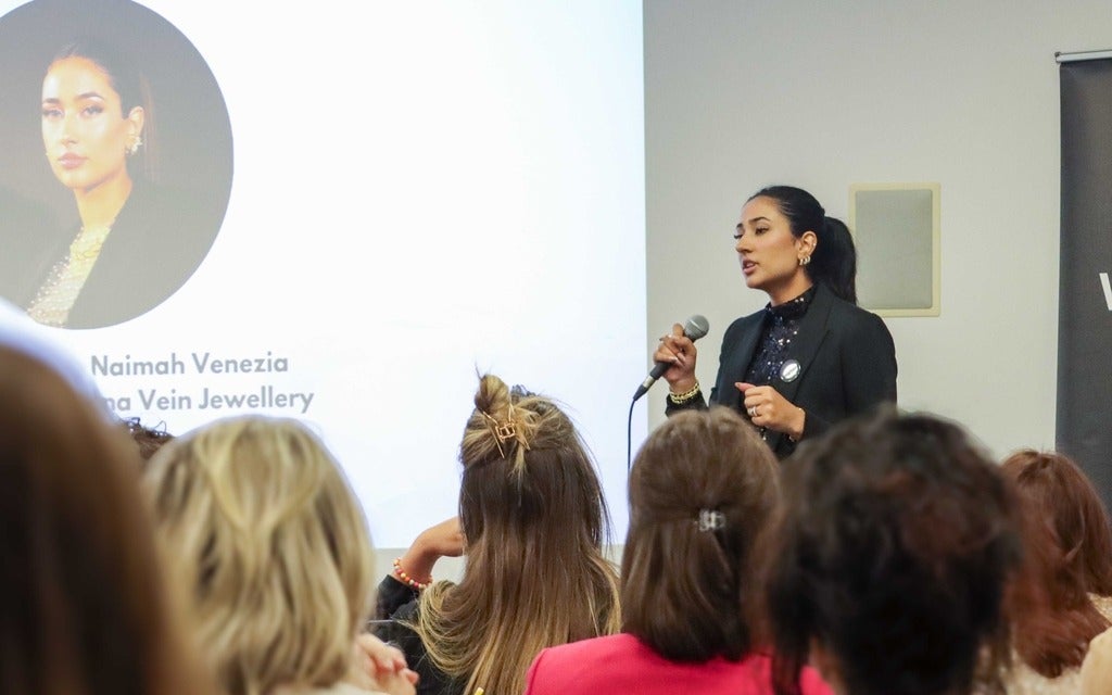 Naimah Veniza presenting in front of an audience