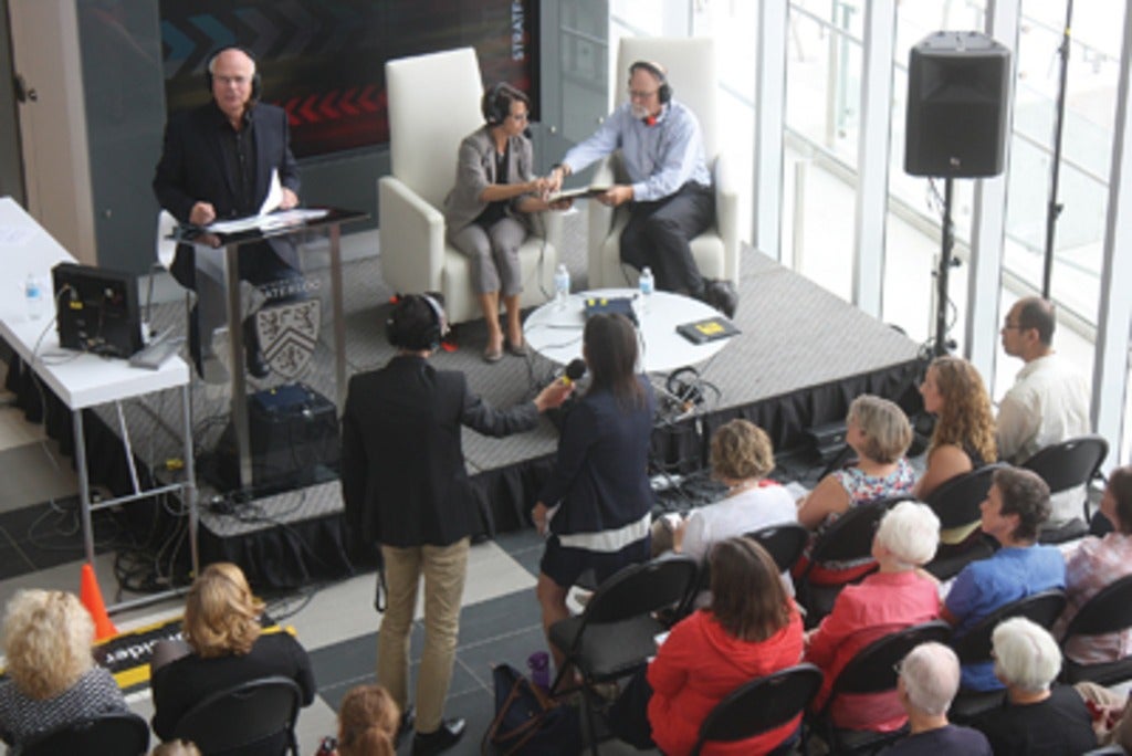 Host Peter Mansbridge, left, discusses the future of libraries with panelists Christine McWebb and Ken Roberts at a live broadca